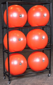 Red exercise balls on metal storage rack.