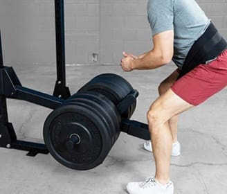 Man lifting heavy weights in gym.
