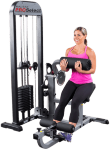 Woman using leg curl exercise machine.