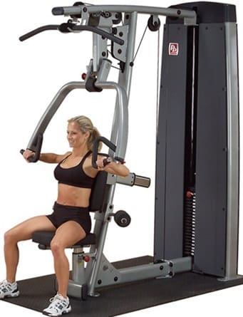 Woman using a chest press exercise machine.