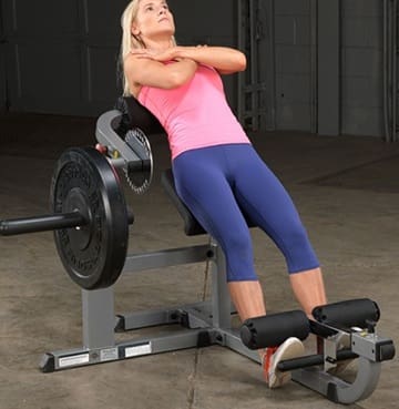 Woman exercising on a Roman chair for back and core strength.