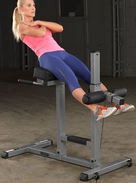 Woman exercising on a Roman chair for back and core strength.