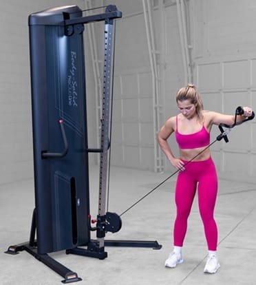 A compact home gym machine with pulleys and adjustable cables for strength training.