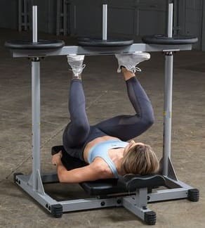 A black workout bench with an adjustable silver squat rack.