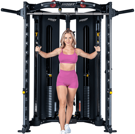 Woman exercising on a multi-functional gym machine.