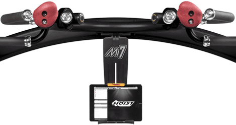 Close-up of a black M1 electric skateboard with a mounted remote control.