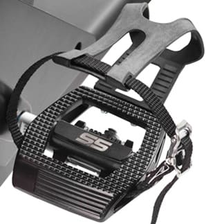 Close-up of a carbon fiber bicycle pedal with toe clip and strap.