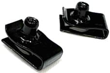 Black circular metal plate with holes and geometric cutouts.