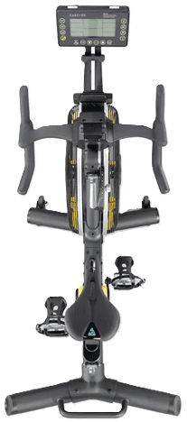 A modern stationary exercise bike with a yellow flywheel.